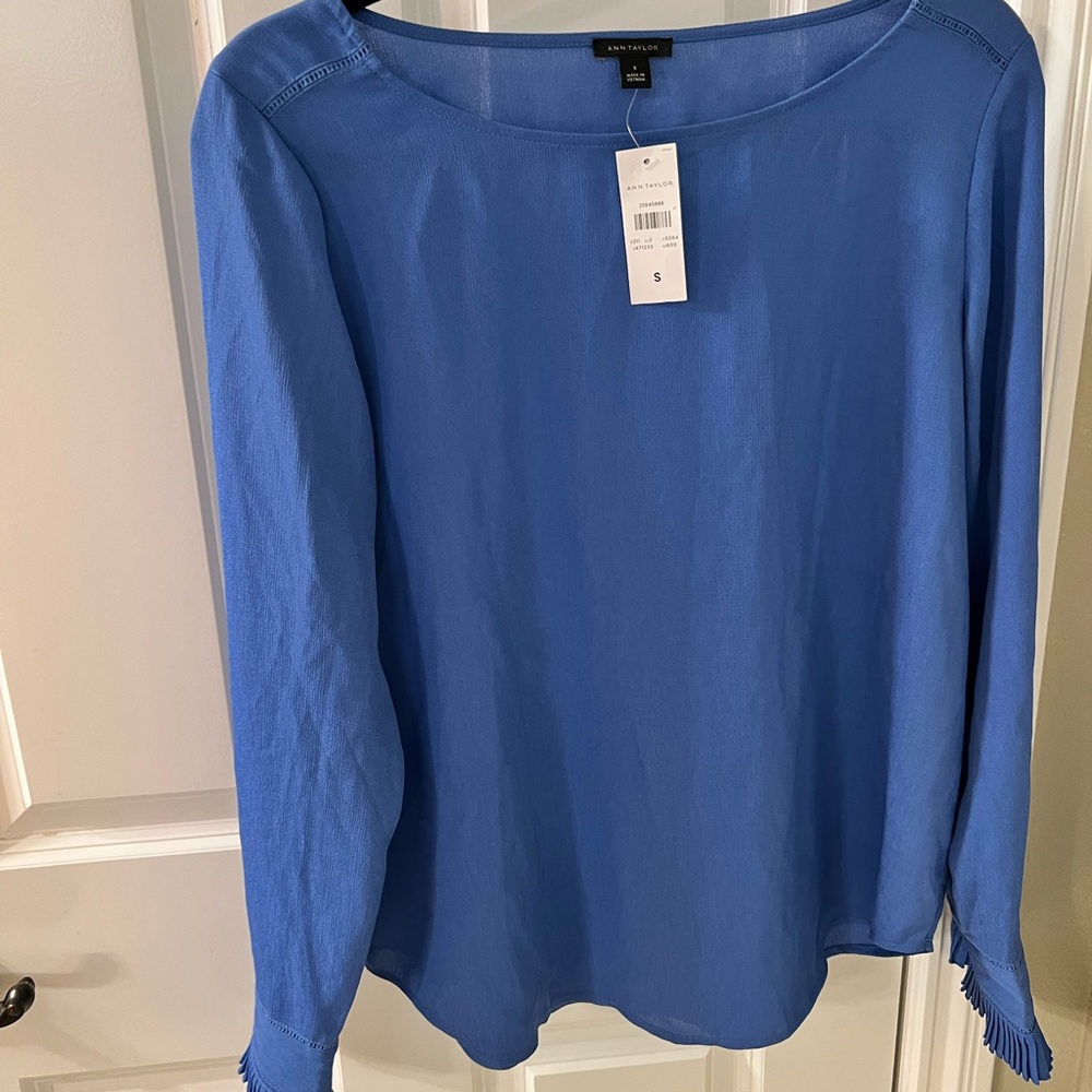 Beautiful blue top with scalloped cuffs with buttons.